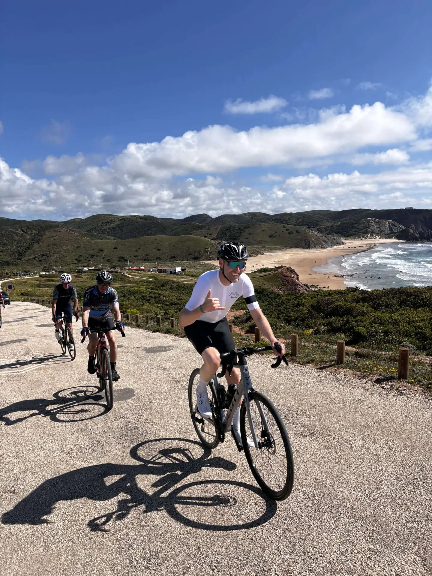 Fietsers op een grindpad langs de Portugese Atlantische kust met strand